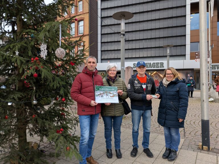 Matthias Kumlehn, Hanna Zota und Sascha Stein von der Holzmindener Tafel und Inga Schaper stehen neben dem "Little Ugly Chrisdtmas Tree" und dem Kaufhaus Schwager im Hintergrund.